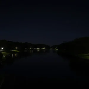 Night view of Lady Bird Lake surrounded by trees and park areas