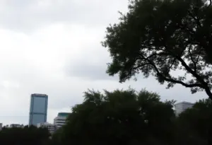 Cloudy skies over Austin, Texas with trees and buildings