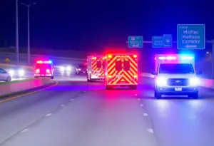 MoPac Expressway closed due to fatal crash, with emergency vehicles present.
