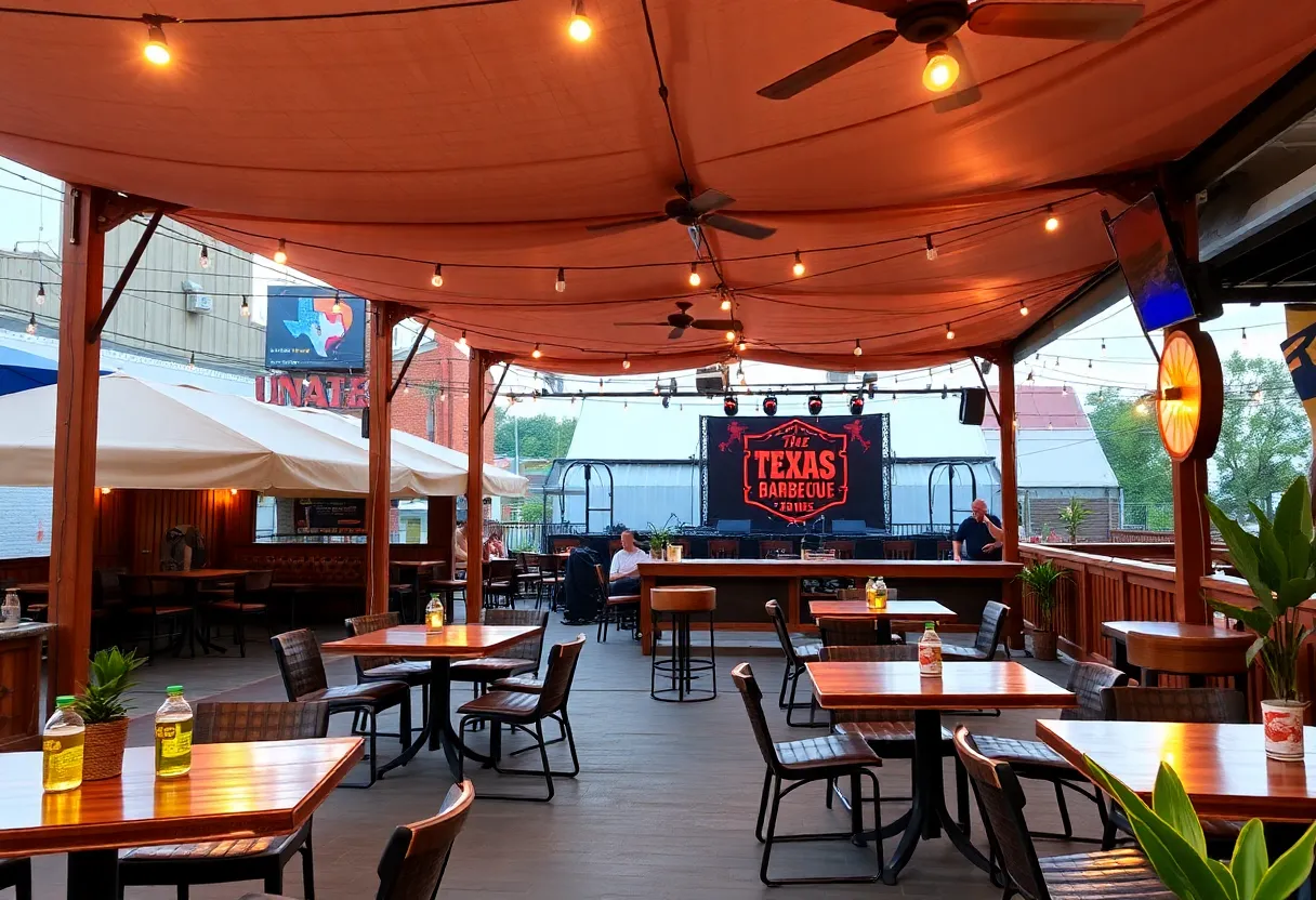 Outdoor dining area of Terry Black's Barbecue in Nashville with tables and live music stage.