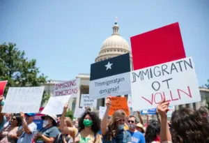 Community members protesting at the Texas Capitol against ICE operations.